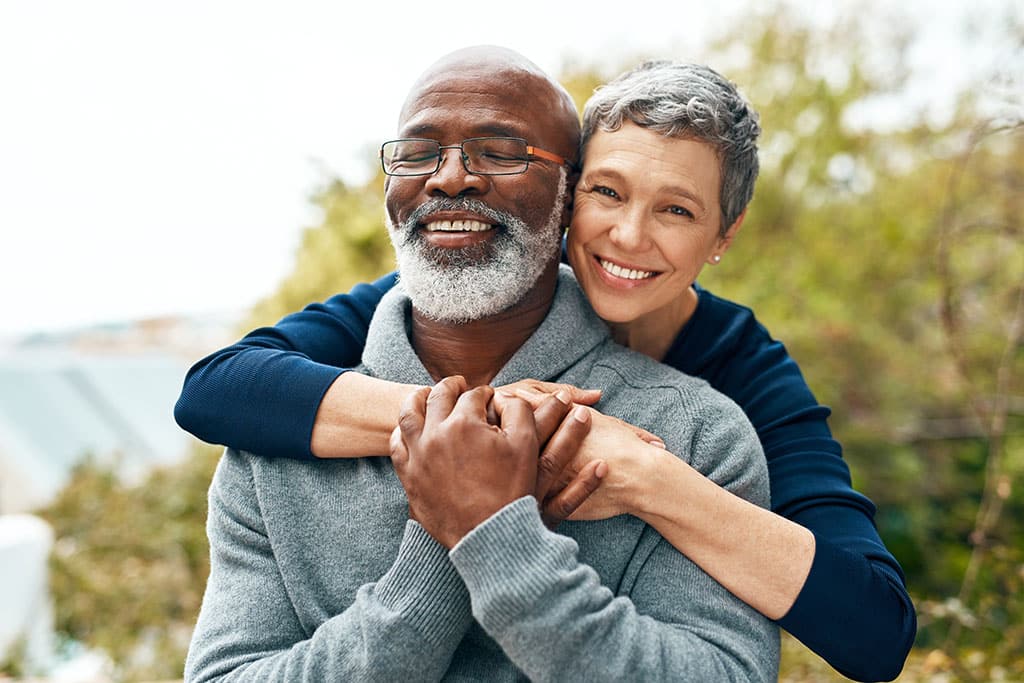 senior man and woman smiling and enjoying a healthy relationship